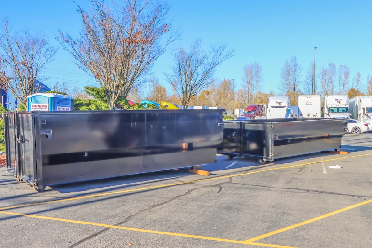 Professional dumpster rental service with roll-off container on residential driveway in Voorhees